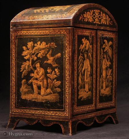 Penwork table cabinet  with curved Regency shape. The penwork depicts exquisite chinoiserie  scenes of figures in the fantastical gardens of Cathay.  The compartmentalized interior was fitted for jewelry in the 19th Century.  The hinged doors open to  four drawers with turned bone handles. The upper part was originally fitted for sewing. The divisions retain their original pink lining paper. The domed top and  flared skirted base are unusual. Enlarge Picture